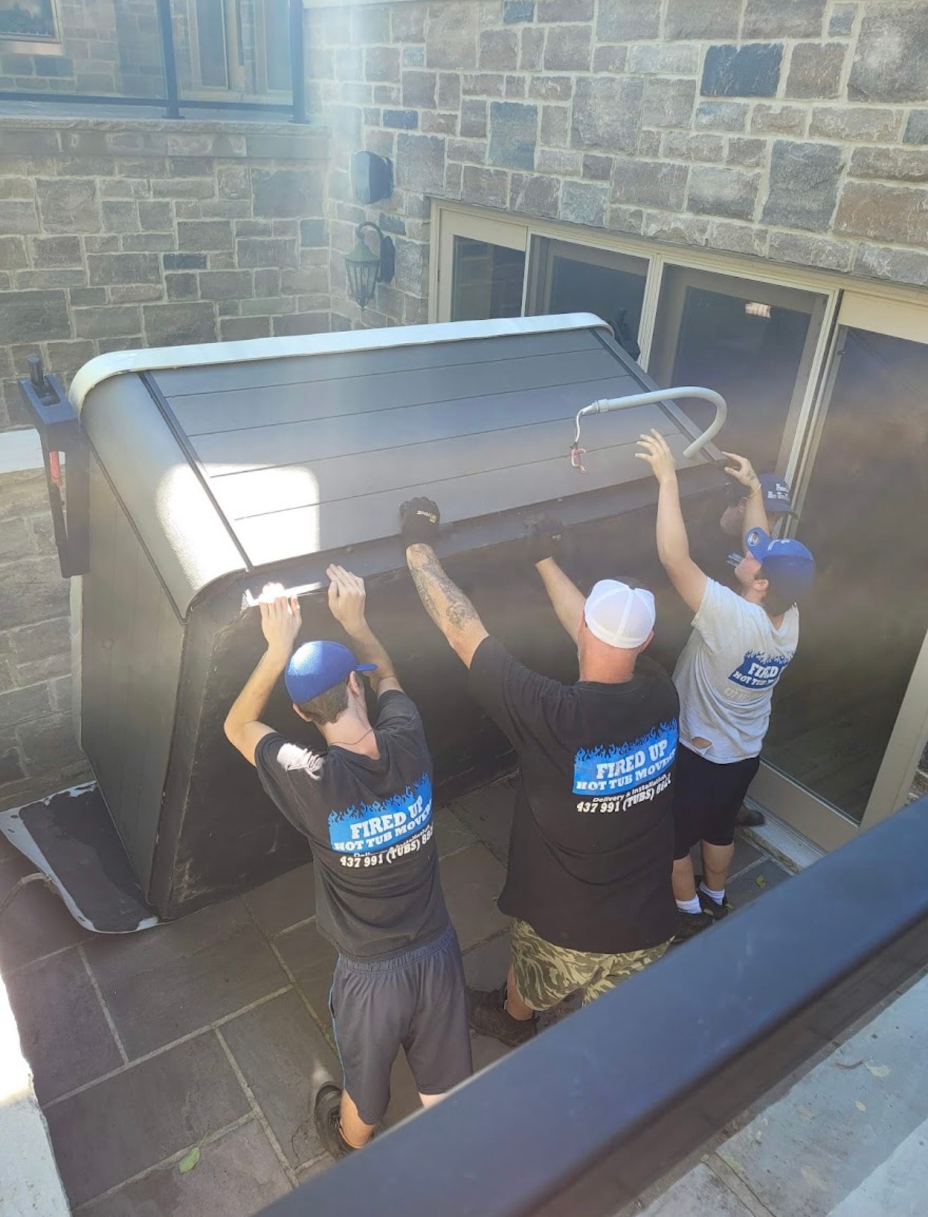 Professional hot tub movers at work