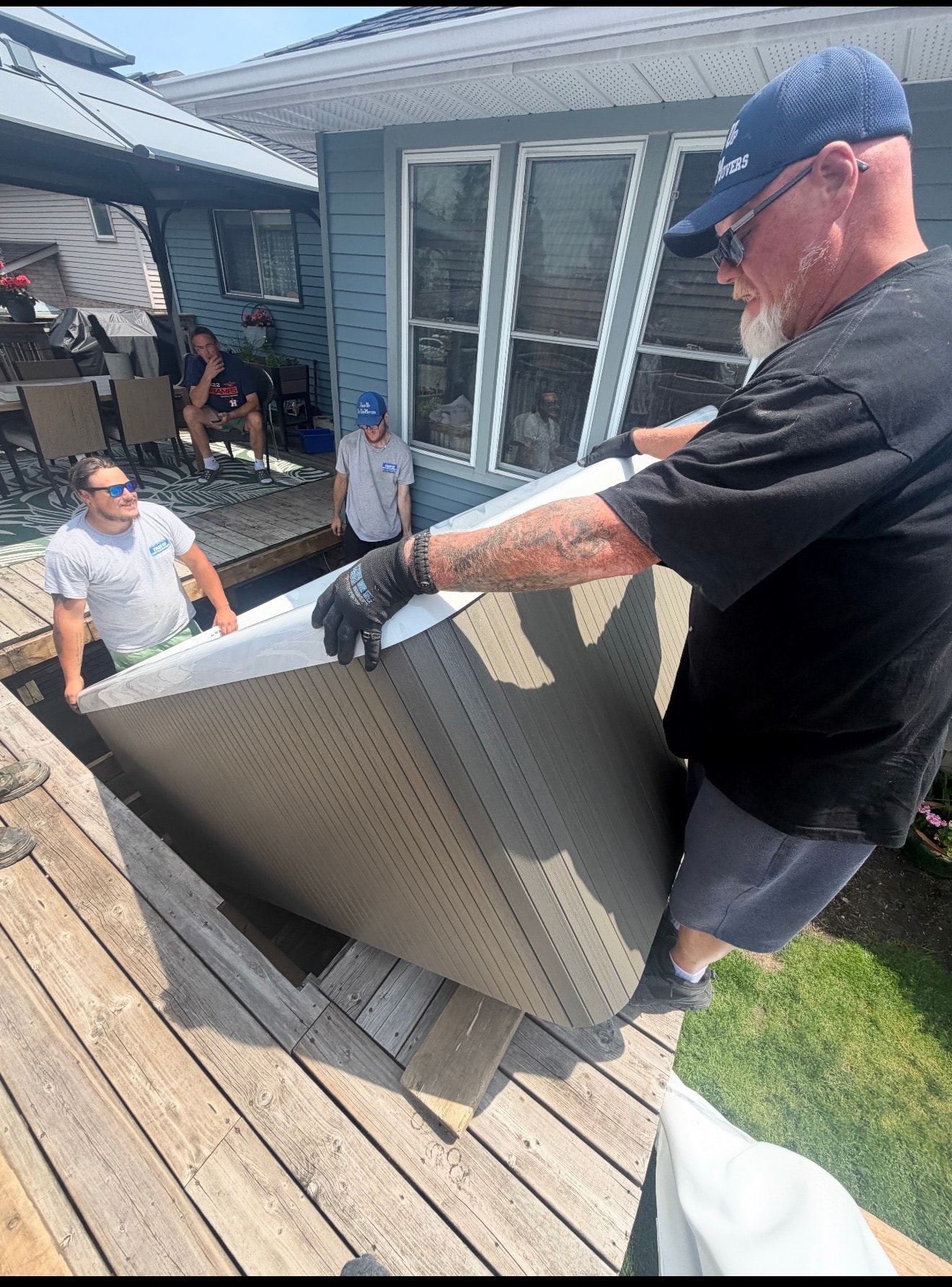 Fired Up crew moving a hot tub indoors