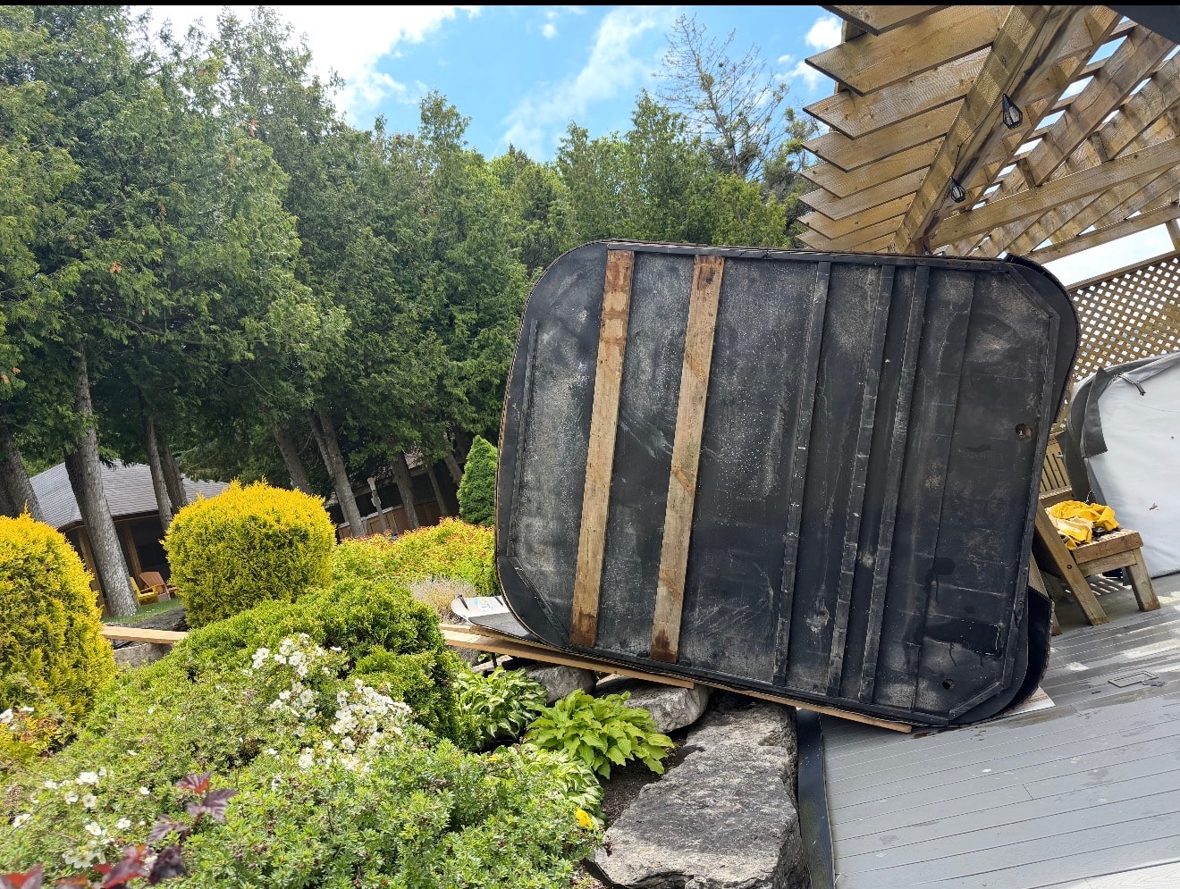 Hot tub tilted on dolly in backyard